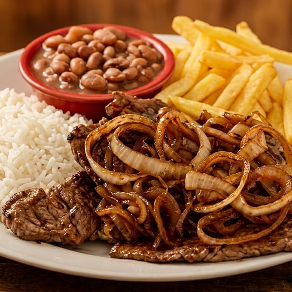 Steak with caramelized onions, white rice, beans, and french fries on a white plate.